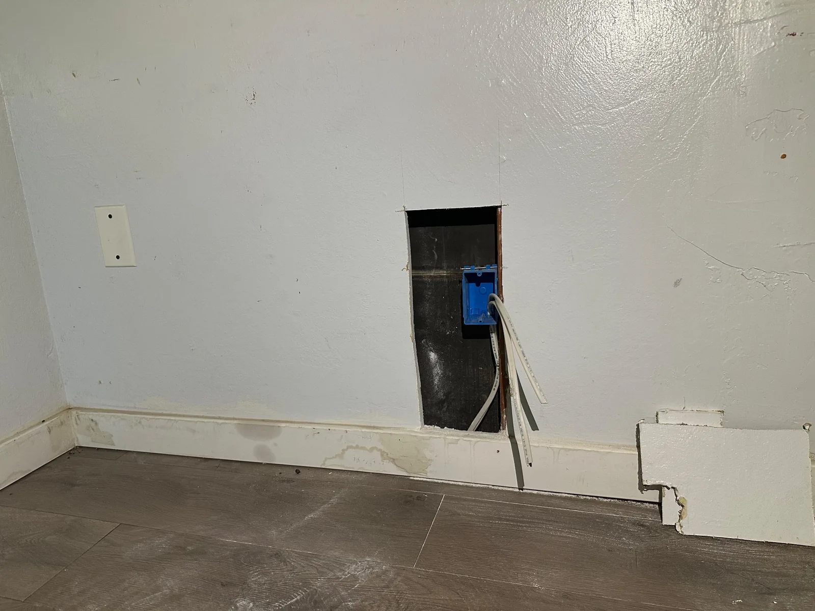 New electrical box and wiring near floor level during whole-house rewiring