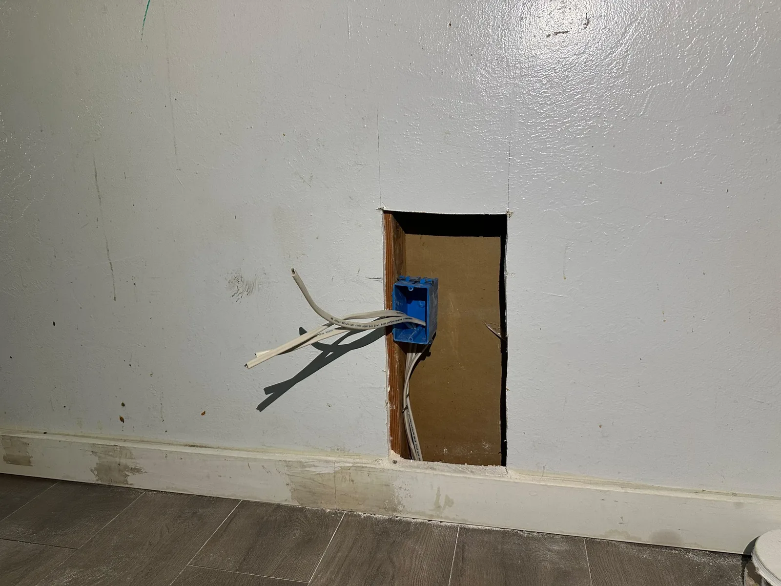 Open wall with electrical box and new wiring during Davis rewiring